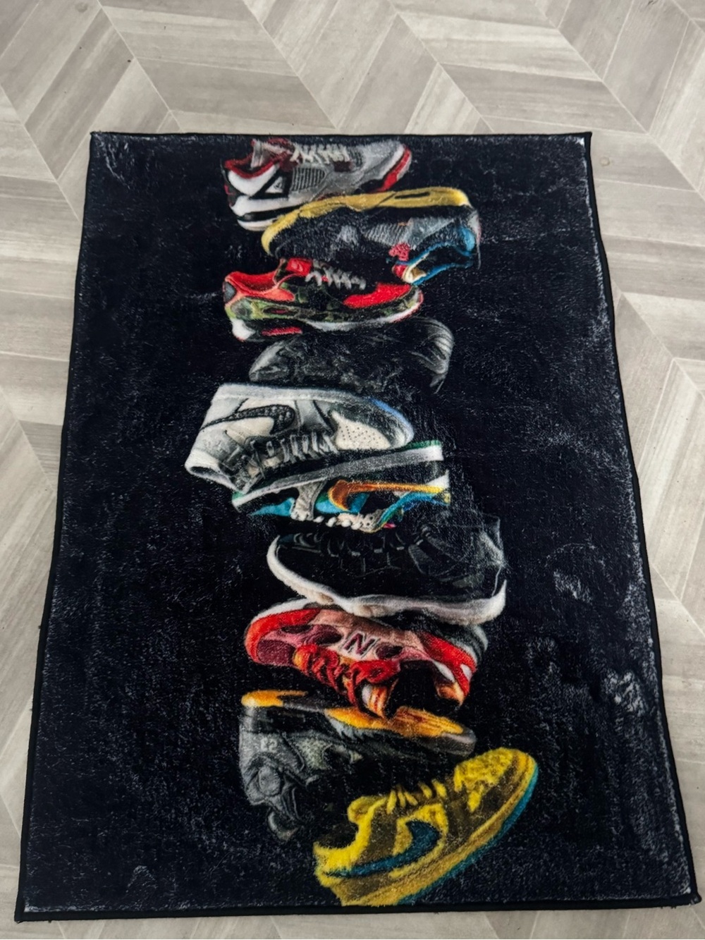 Sneaker Stack Graphic Rug in Black Shoe Prints 35x24 IN. TUFTED PLUSH